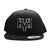Black 6 panel snapback with stacked HyH logo in white and black puff embroidery. Grind, Hustle, Grit. 